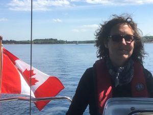 First Mate at the Helm on a Private Sailing Tours on Mahone Bay Nova Scotia